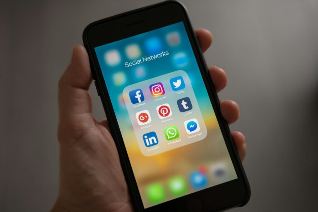 pexels-photo-607812-607812 Person Holding Iphone Showing Social Networks Folder